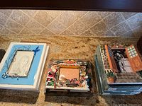 Three unboxed frames showing designs and size openings