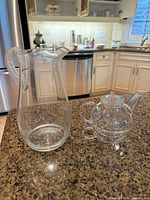 Pitcher and assembled teapot side by side on countertop