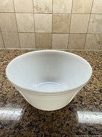 Side view of white milk glass bowl