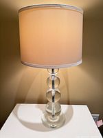 Full view of first acrylic table lamp with shade