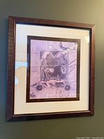 Framed lion print in dark brown frame, shows matting and artwork