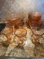 Overall view showing serving bowl, stacked bowls/plates, and six sherbet glasses