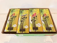 Tray containing four identical boxed solar bird stake lights