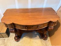 Top view of serpentine console table showing veneer and finish