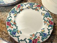 Front of dinner plate showing Victoria pattern