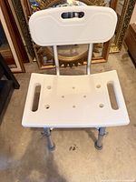 Front view showing plastic seat, backrest, aluminum legs, drainage holes