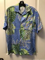 Front view of blue tropical leaf silk shirt