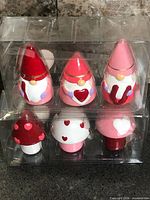 Full view of both sealed plastic packs showing gnome and mushroom sets