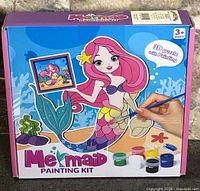 Front of box showing mermaid painting kit contents and age recommendation