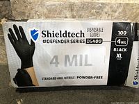 Front of Shieldtech DS400 glove box showing 4 mil, black, XL, powder-free details