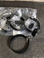 Four egg rings inside sealed bag plus one displayed, showing size and handles