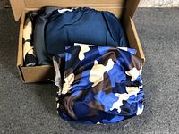 Box containing multiple blue camouflage male dog diaper bands