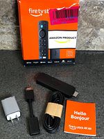 Retail box front with stick and accessories laid out