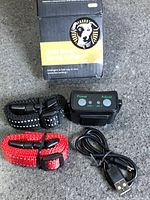 Complete contents: spray collar device, USB cable, two straps, box