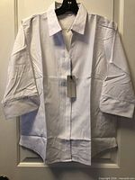 Front view of white Biz Collection shirt with tags attached