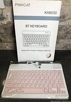 Retail box front showing brand PINKCAT, model KHB030 and compatibility, keyboard and cable visible in packaging