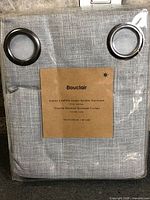 Front of sealed Bouclair curtain package showing fabric and grommets