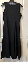Front view of black sleeveless dress on hanger