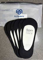 Front view of five pairs black no show socks with packaging