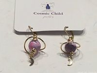 Front view of both earrings on Cosmic Child card backing
