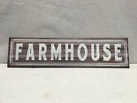 Front view showing FARMHOUSE text and faux wood design