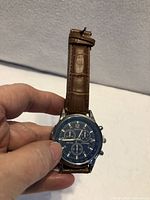 Front view of Geneva chronograph watch showing blue dial and brown strap