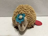 Front view showing face, flower accent, quill texture