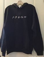 Front view of black Jerzees Fresh hoodie on hanger