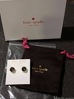 Earrings on card with pouch and box visible