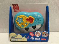 Front of sealed box showing blue piano console and branding