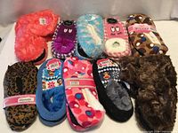 All ten pairs of assorted slippers displayed