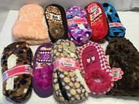 All ten pairs of assorted plush slippers displayed