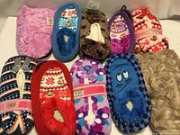 All 10 slipper pairs laid out showing variety