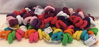 Pile of Goody Ouchless ponytail holders showing variety of colours and attached tags