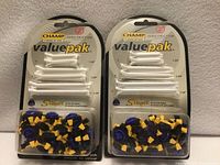 Front view of two sealed Champ Valuepak packs showing tees and spikes
