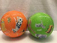 Orange and green Crocodile Creek playground balls side by side