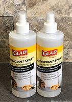 Front view of two Glad Attractant Spray bottles