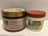 Both hair care containers front view