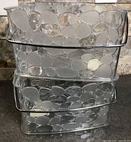 Three stacked clear pebble-pattern plastic caddies showing overall design and handle