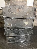 Two stacked clear pebble-design caddies showing side profile and metal handles