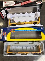 Overview showing both flatcars in original Atlas and Athearn boxes