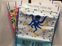 Front view of octopus "Wild & Free" drawstring bag with visible packaging header