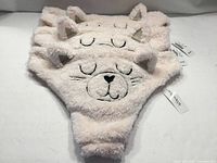 Stack of three fuzzy pink cat-face panties with tags visible