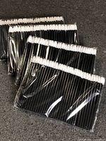 Four sealed packs of black-handled white-tip applicators