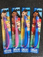 Front view of four sealed Oral-B Disney Princess kids toothbrushes