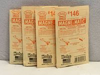 Front view of four Kadee #146 Magne-Matic coupler packs