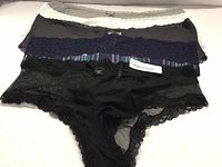 Five stacked panties showing colours and lace details