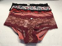 Stack of five La Vie en Rose panties showing colors, patterns, tags attached
