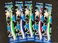 Front view of five sealed Oral-B kids toothbrushes on card backing