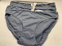 Stack of four heather blue briefs showing front and attached tags